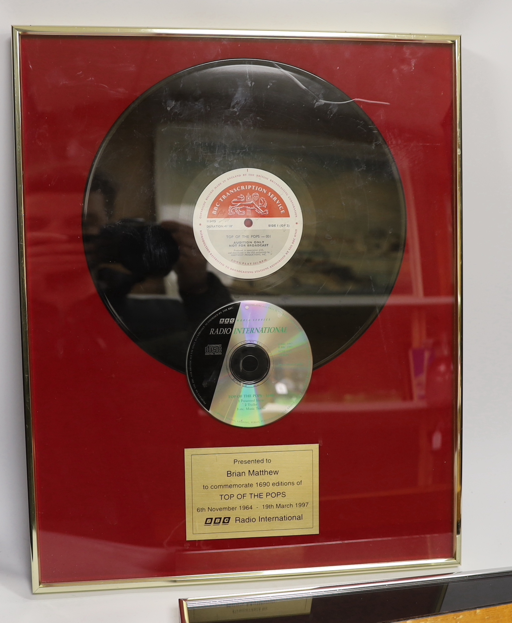 Three framed BBC related presentations to the BBC DJ Brian Matthew; ‘The Beatles - Live at the BBC’, presented by EMI Records, Top of the Pops presented to mark the 1000th edition (28.11.83), Top of the Pops, presented t